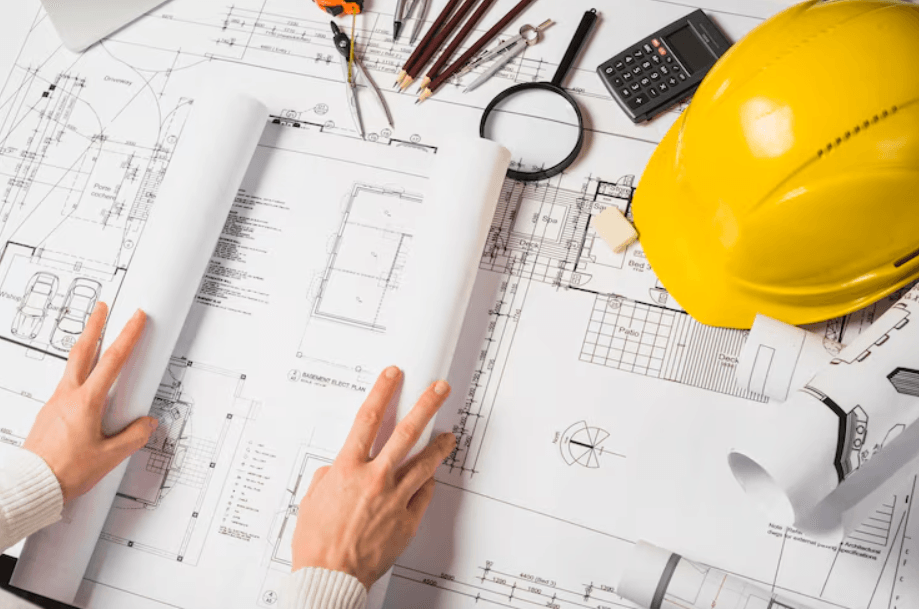 objetos que um engenheiro civil utiliza sobre a mesa